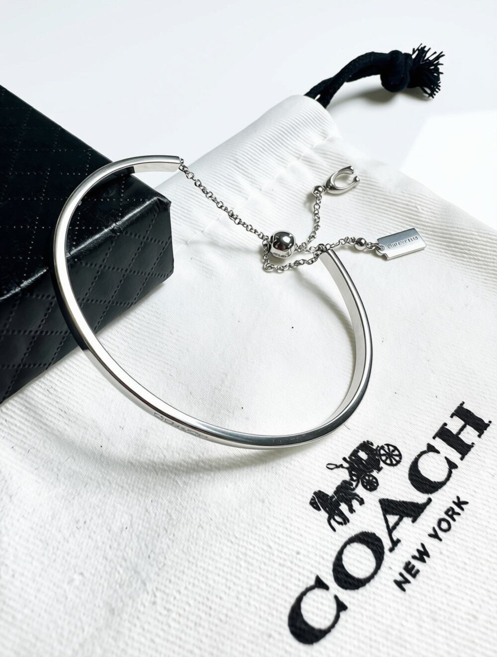 This Coach Signature Silver Tone Slider